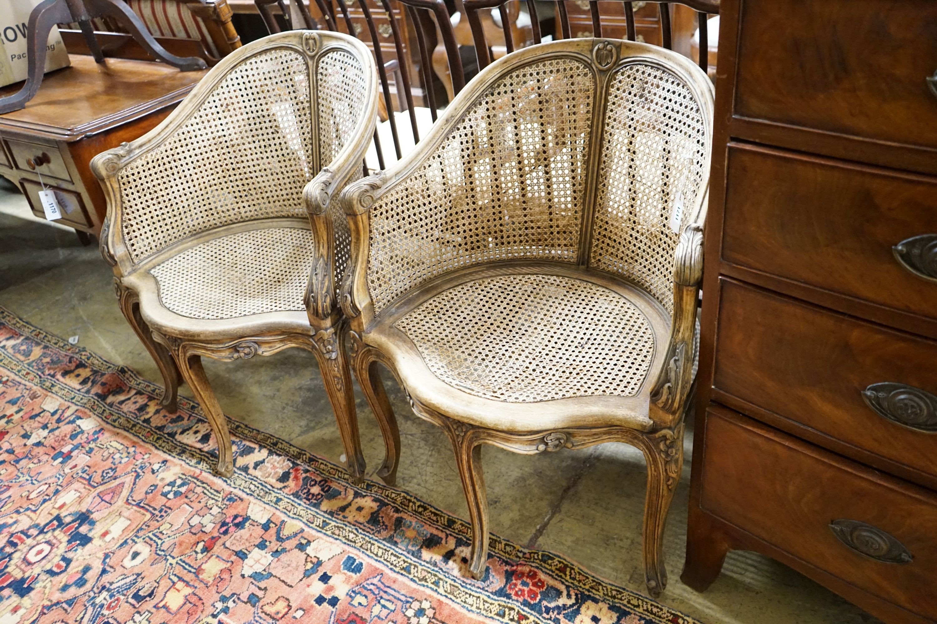 A pair of early 20th century French caned, carved beech Bergere chairs